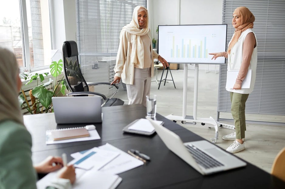 A focused professional analyzing financial data on a laptop in a well-lit workspace.